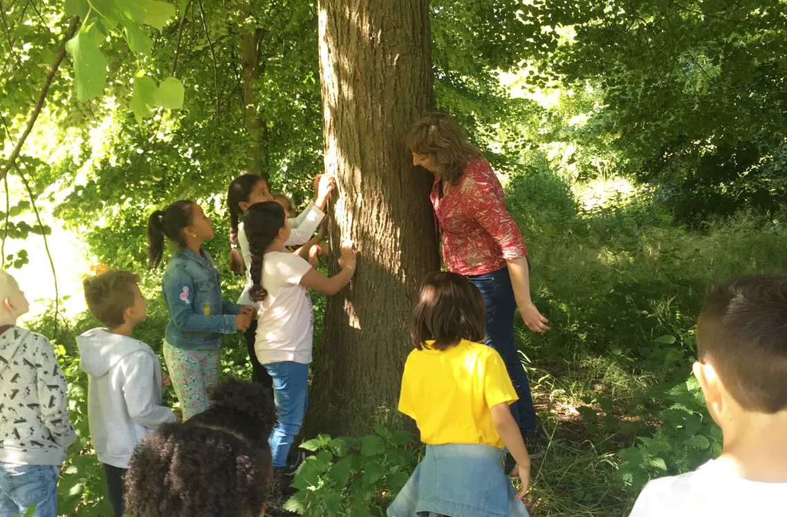 Natascha bij boom met kinderen